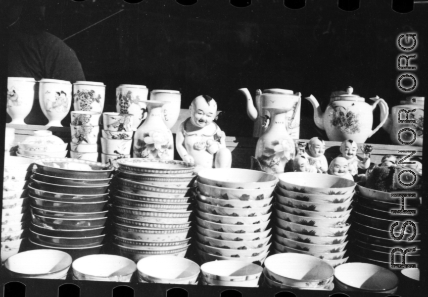 Decorative china cups, tea pots, and figurines in a china shop in China during WWII.