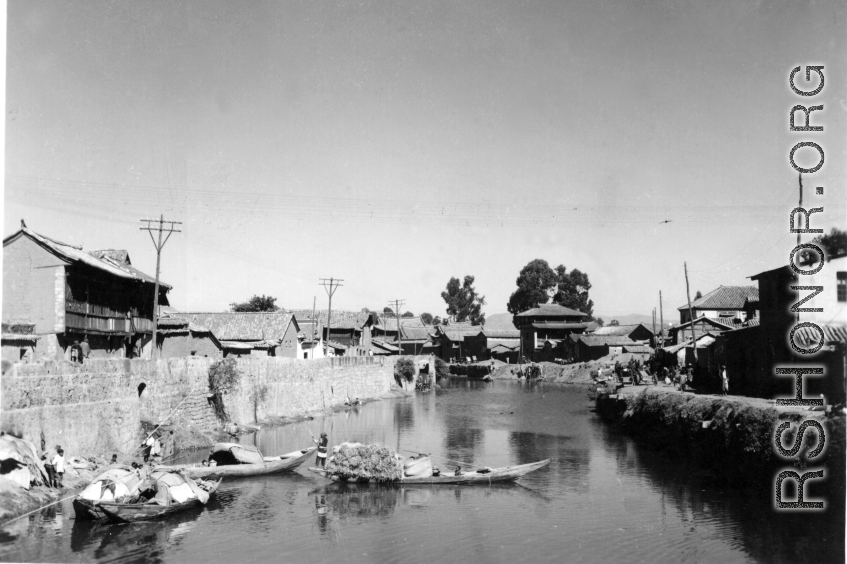 A canal near Kunming, China, during WWII, with boats.  From the collection of Hal Geer.