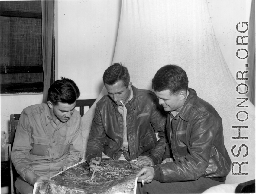 American flyers look over aerial image in the CBI during WWII.
