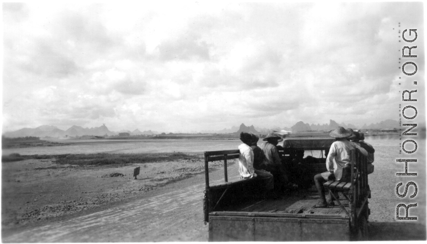 Chinese workers riding transport on the US air base at Liuzhou. During WWII.  From the collection of Frank Bates.