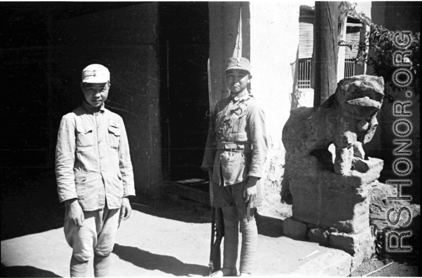 Two very young Chinese soldiers keeping guard in SW China during WWII.