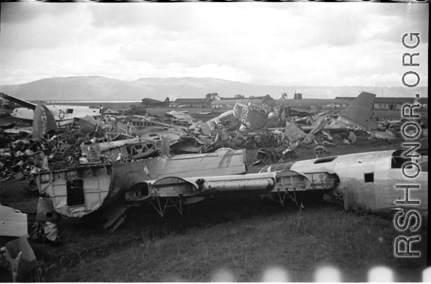 A bone yard of wrecked American military aircraft during WWII at Luliang, Yunnan province, China, looking east.  In this image are easily recognized C-46 and B-24 air frames.