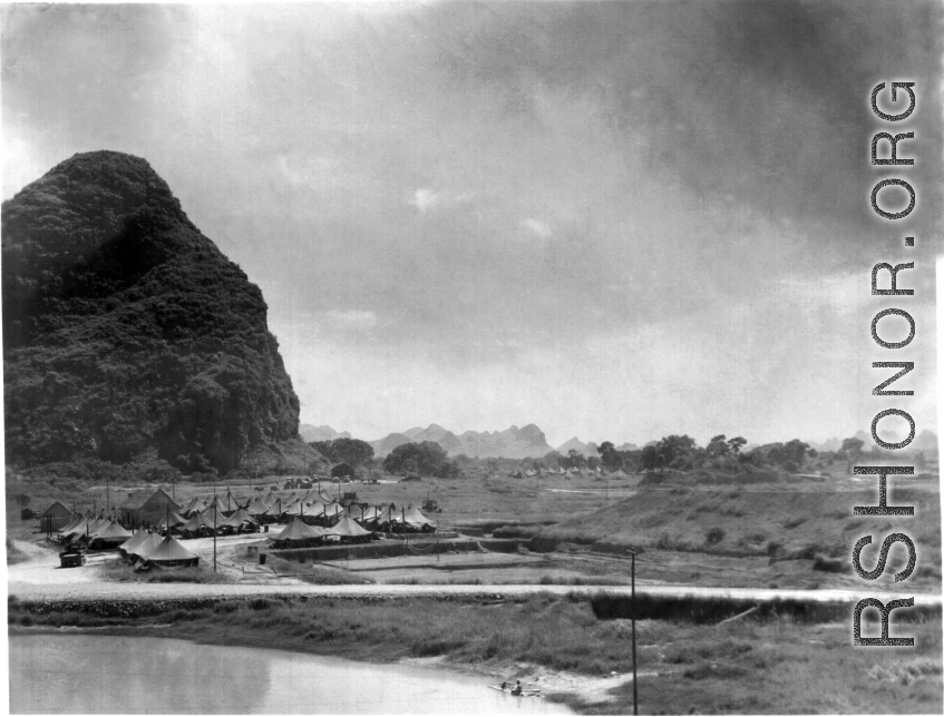 Tents for GIs at the American base at Liuzhou during WWII. Not the man fishing in the lower right, and the volleyball court right below the tents in the middle.