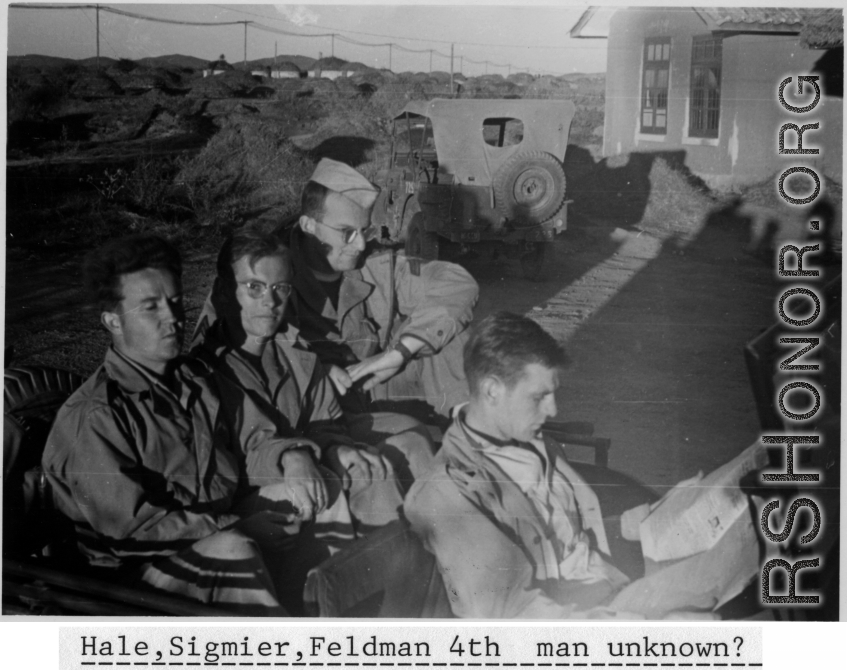 "Hale, Sigmier, Feldman  4th man unknown?" sitting on a jeep at a base in Yunnan province during WWII.