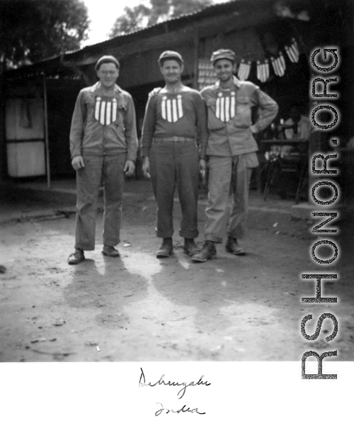 GIs with banners stuck to their chests, apparently purchased from the shop immediately behind them. In India during WWII.
