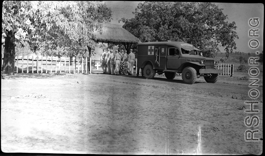 Bearers carry an American who has died from an ambulance to a temporary war-time graveyard. In the CBI, during WWII.
