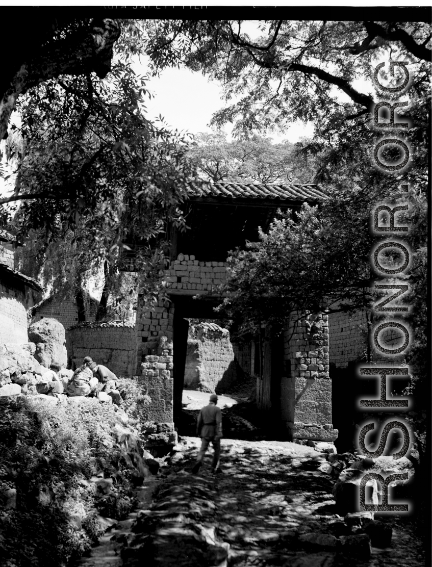 A village passageway through a village gate in Yunnan province, China. During WWII.