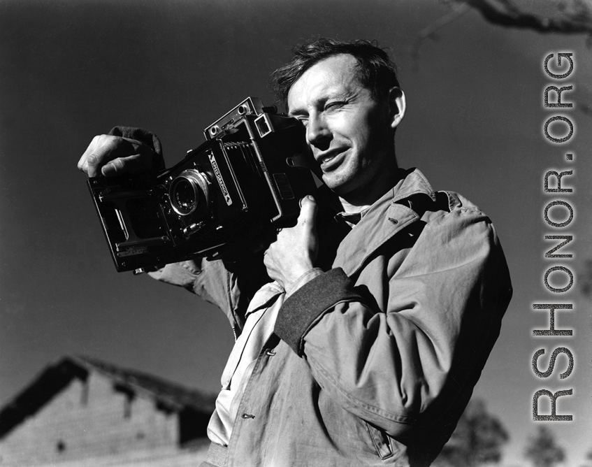 Eugene T. Wozniak, combat photographer for the 491st Bomb Squadron, with a Speed Graphic camera in Yunnan, China, during WWII.