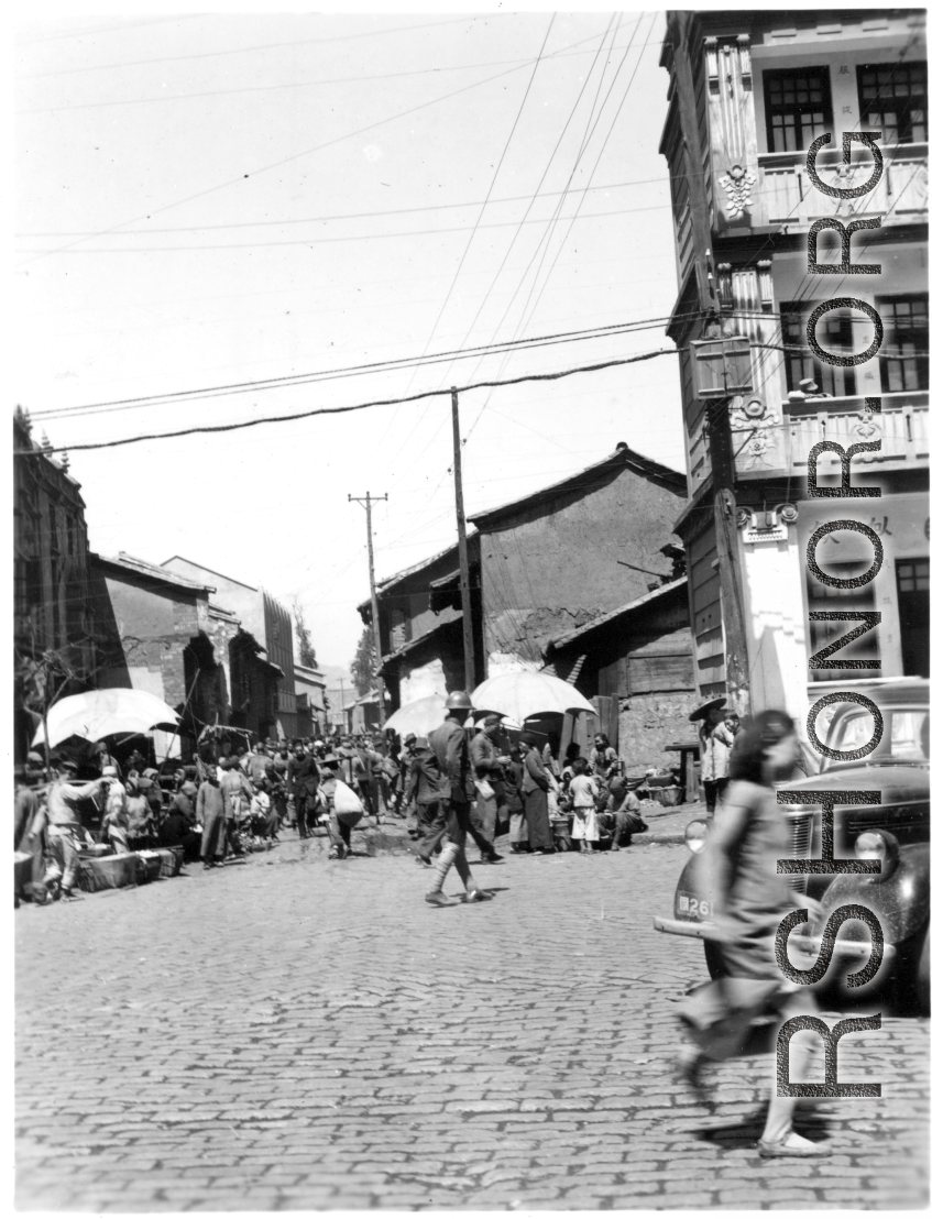 Market crowded with local people in in Kunming city, Yunnan province, China. During WWII.