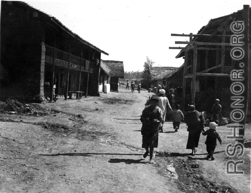 People go about lives in small township in China during WWII.