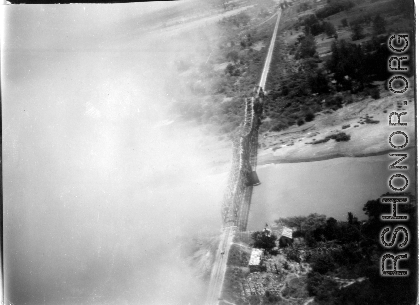 B-25 Mitchell bombers have just bombed a railroad bridge a bridge somewhere in southwest China, Indochina, or Burma, leading to no apparent damage, but a large cloud of dust and smoke. 