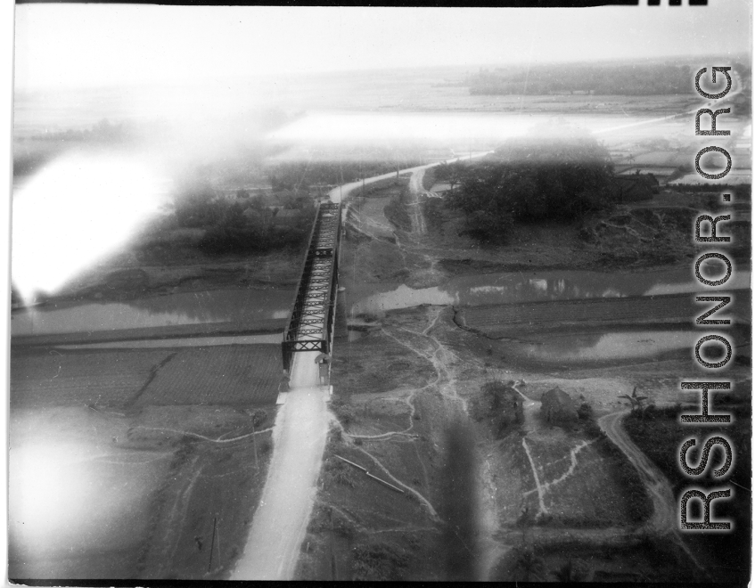 Aerial view of auto bridge and fields in either SW China or French Indochina, in the CBI, during WWII.