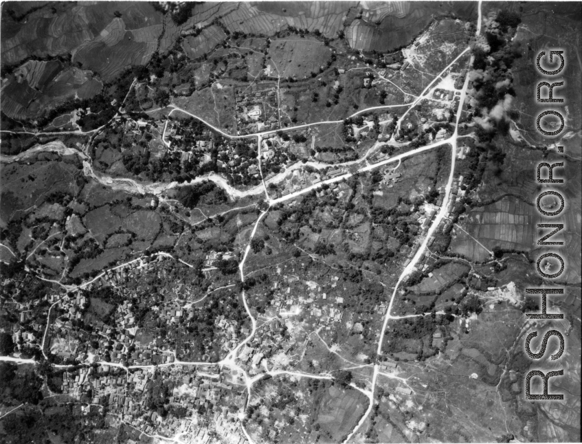 Bombing of large village area with evidence of much previous bomb damage in a region of savanna, either in Burma or French Indochina. During WWII.