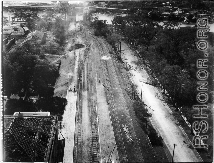 Large crater and tracks shifted wholesale during bombing on Phu Lang Thuong railway bridge over the Thuong River at Bắc Giang City in French Indochina (Vietnam), during WWII. In northern Vietnam, and along a critical rail route used by the Japanese.  Coordinates:  21°16'32.69"N 106°11'9.28"E  The low level that these B-25 crews flew at times is truly remarkable, as evidenced in this image.