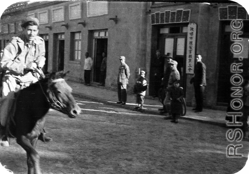 American Navy GI riding a mule in a small town in Northern China, Shaanba Town, Inner Mongolia.  内蒙陕坝市。