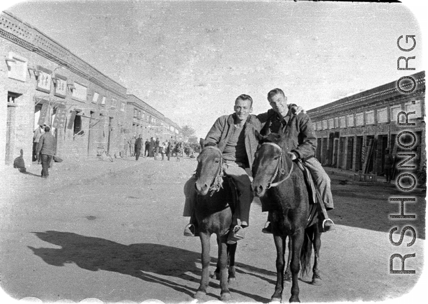 SACO men on mules on the street in Shaanba (陕坝镇), Inner Mongolia, China, during WWII.