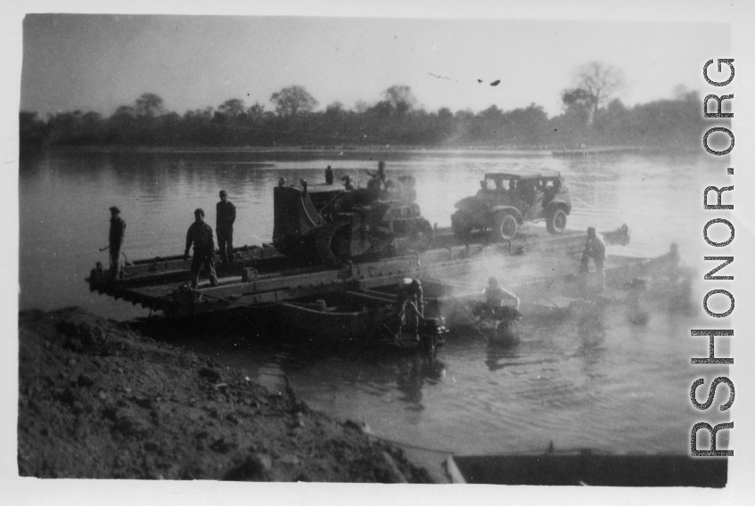 Bulldozer on ferry on river in Burma.  During WWII.  797th Engineer Forestry Company.