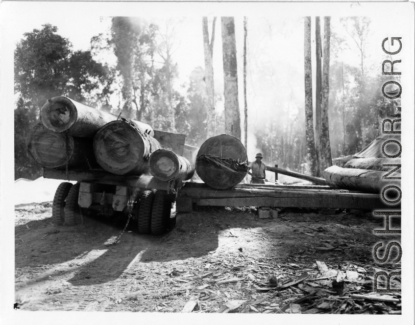 Site at the mill yard, a large truck unloading logs at a lumber mill of the 797th Engineer Forestry Company in Burma.  During WWII.