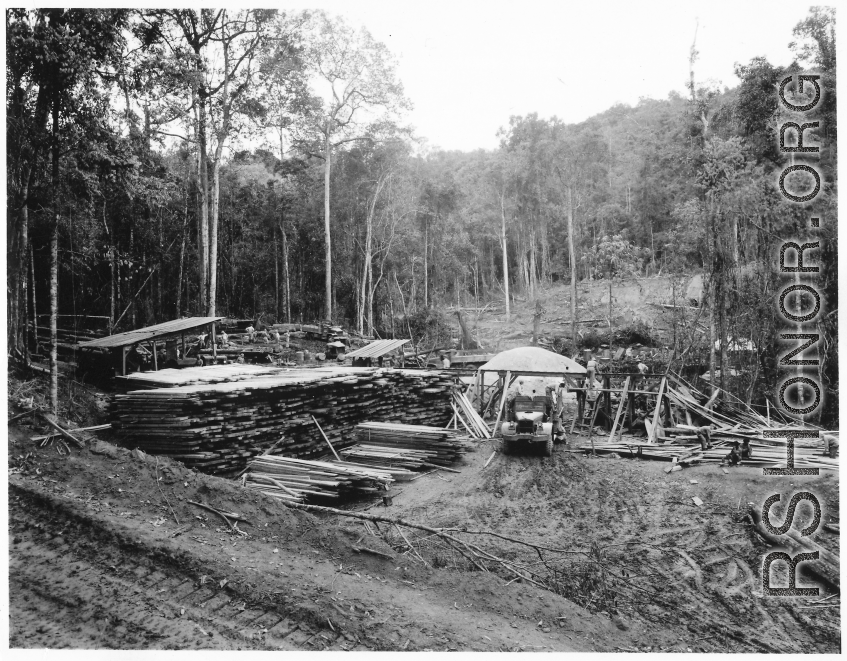 Site at the mill yard, of GIs sorting planks after ripping logs at a sawmill of the 797th Engineer Forestry Company in Burma.  During WWII.