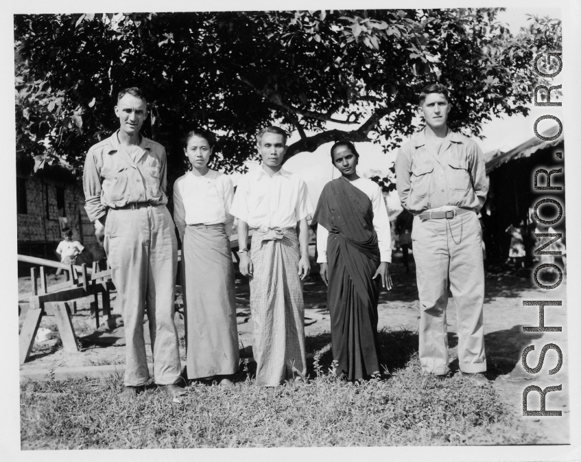 Local people in Burma near the 797th Engineer Forestry Company--GIs pose with man and two women in Burma.  During WWII.