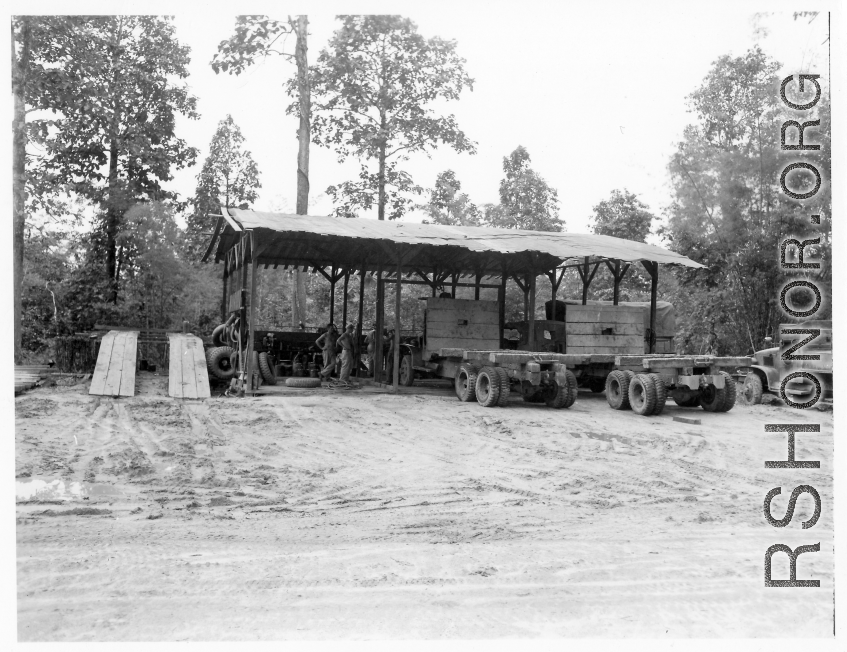 Engineers of the 797th Engineer Forestry Company at work at a truck repair garage at camp in Burma.  During WWII.