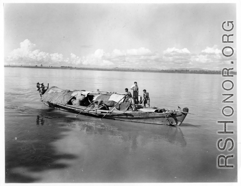 People pole a boat in Burma.  Local people in Burma near the 797th Engineer Forestry Company.  During WWII.
