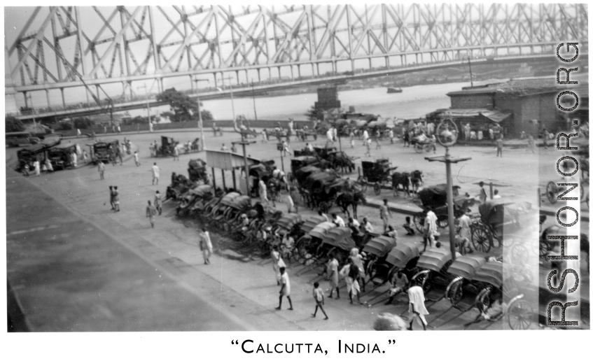 Rickshaw pullers and carriages await at Howrah Bridge in Calcutta, India, as seen by 2005th Ordnance Maintenance Company, 28th Air Depot Group, in India during WWII.
