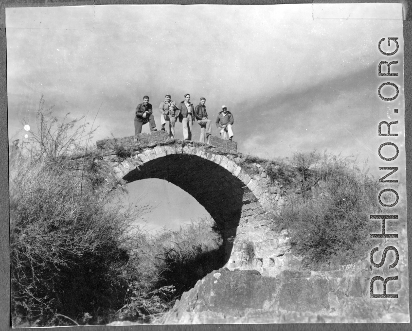American flyers exploring thin stone bridge at Chanyi (Zhanyi), during WWII.