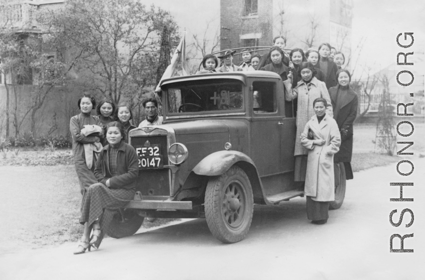 Alice Chong sitting on the bumper of a British truck in Shanghai in February or March of 1938. 