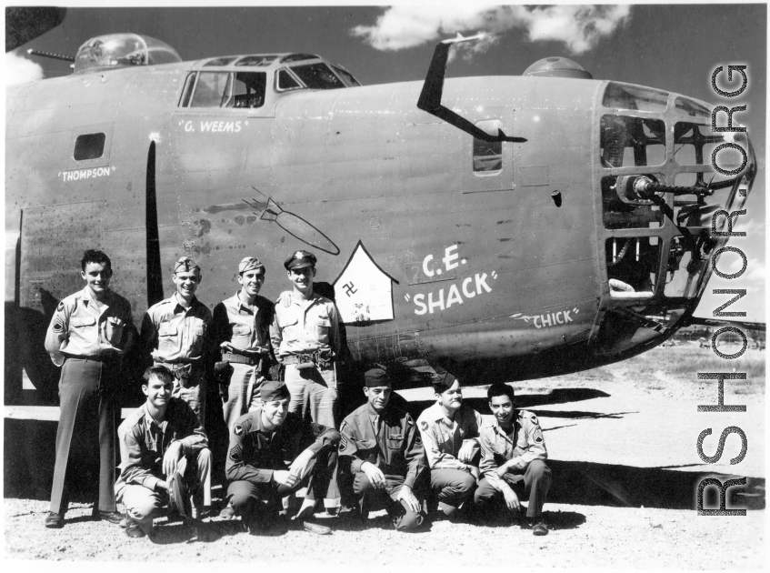 "C. E. 'Shack'" with crew on the ground. 425th Bomb Squadron, 308th Bombardment Group.  Names painted on the nose of "C. E. 'Shack'" include those of 2nd Lt. Gordon C. Weems (copilot), 2nd Lt. Charles R. Thompson (navigator), and an unknown "Chick," who was possibly bombardier. (Info courtesy of deployment name list.)