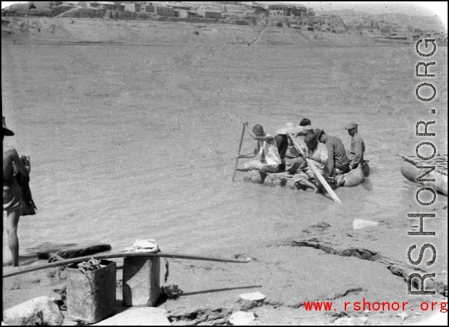 Men ride sheep-skin raft in northern China during WWII, most likely on Yellow River.