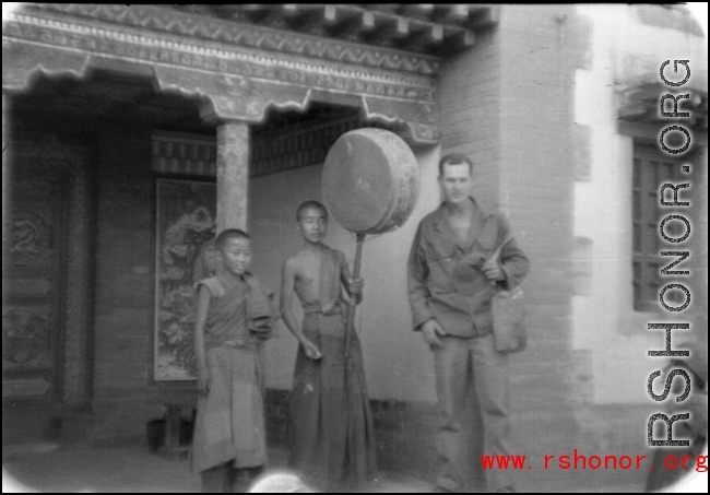 GI poses with monks or trainees at a Lamist temple in northern China during WWII.