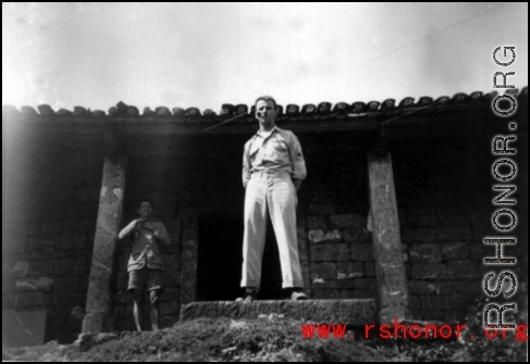A GI stands in a doorway of a building in China during WWII.