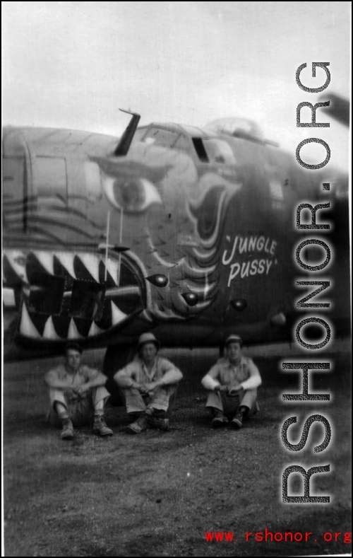 American soldiers sit below the B-24 bomber "Jungle Pussy" in the CBI during WWII.