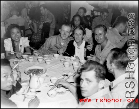 16th Combat Camera Unit members and others--including a few obvious civilians--enjoy a banquet in China during WWII. 