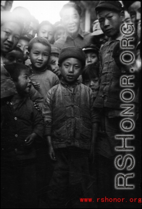 Local people in southern China during WWII: A cool kid in front of the photographer. During WWII.