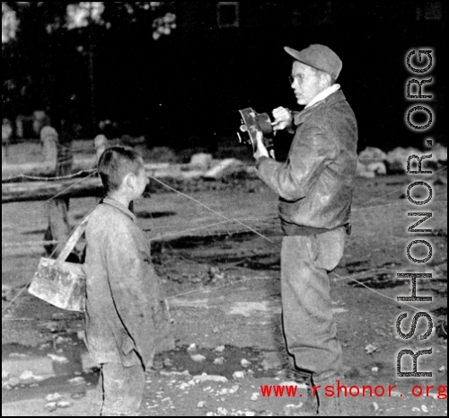 16th Combat Camera Unit photographer Hal Geer takes pictures in China during WWII. The person with him might be an assistant.