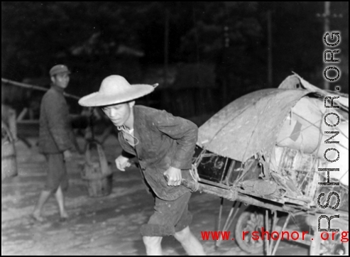 A fleeing Chinese refugee pulls possession on a cart in Guangxi province, China, during the fall of 1944, in the face of the Japanese Ichigo campaign.