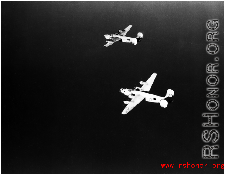 B-24 bombers in flight over water in the CBI. 