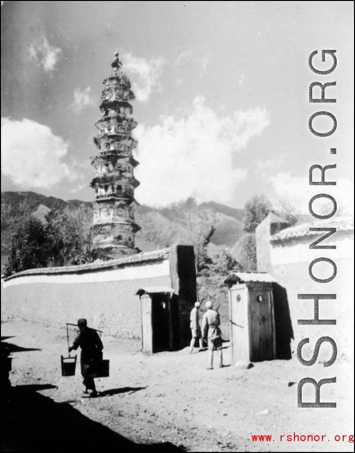 Nationalist troops and guard booths outside pagoda in Dali, Yunnan province, China, during WWII. This is one of three pagodas within a single walled compound. The compound a had been appropriated for use by Nationalist troops. Later, after the communist revolution, the compound was also used by troops, but by PLA troops.