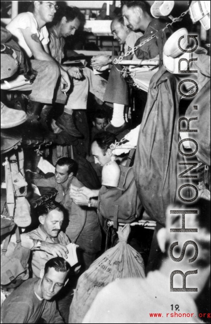 GIs crowded very tightly on bunks on ship on the way back to the US after the war. The ship is probably the SS Marine Raven.
