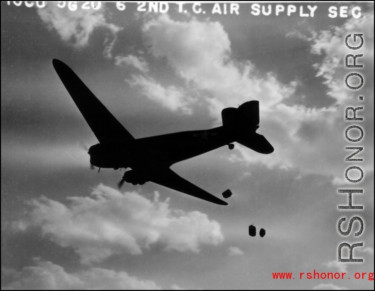 A US C-47 cargo plane drops supplies from the air. ...  10 CU...  2ND T.C. AIR SUPPLY SEC.