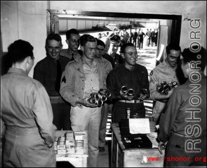 Happy servicemen receiving beer and cigarettes in the CBI.