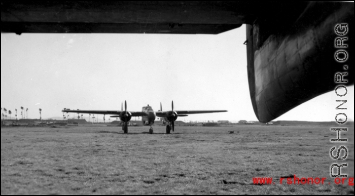 A P-61 Black Widow framed by the tail of another P-61 China. During WWII.