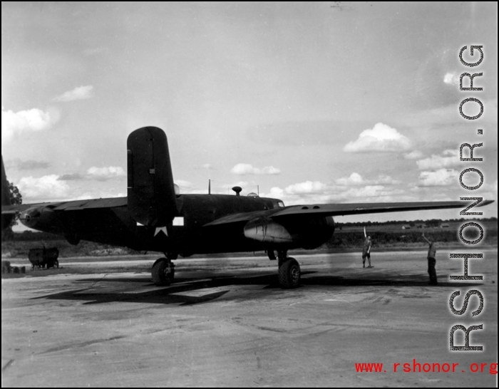 A B-25 in the CBI is directed to taxi by ground personnel.