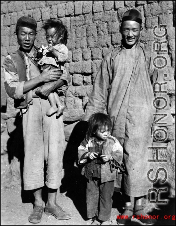Local people in a village in China, probably in Yunnan province.  From the collection of Wozniak, combat photographer for the 491st Bomb Squadron, in the CBI.