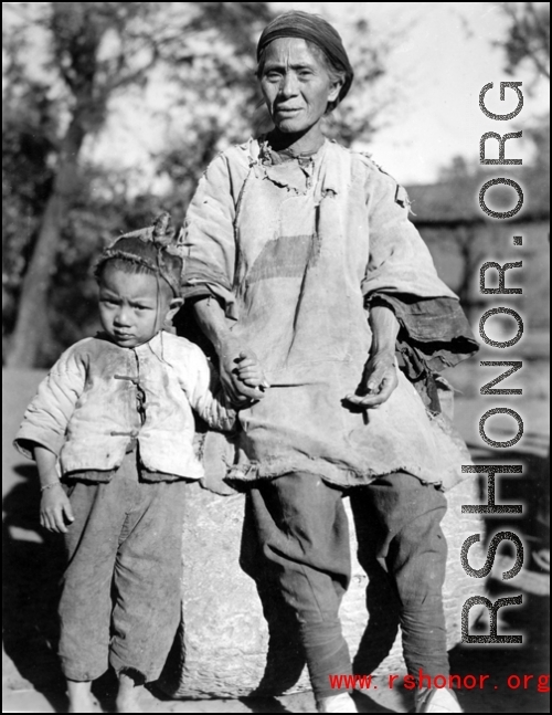 Local people in China, probably in Yunnan province during WWII: An elderly woman and child.