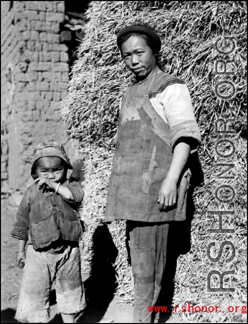Local people in China, probably in Yunnan province: Woman and child village.