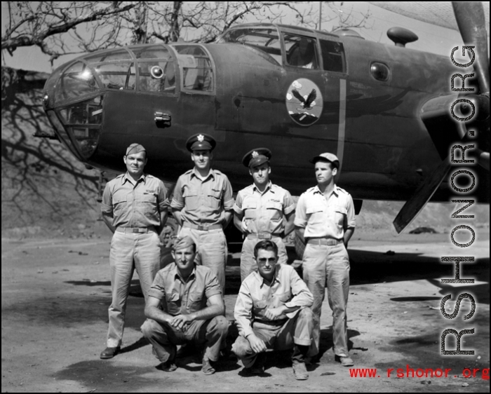 Officers of the 22nd Bombardment Squadron stand before one of the squadron's B-25D's at Chakulia Air Base, India.