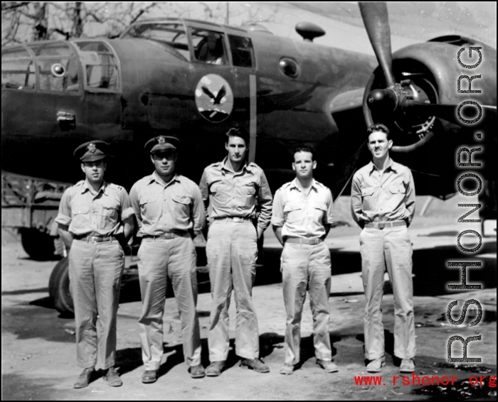 Officers of the 22nd Bombardment Squadron stand before one of the squadron's B-25's (C or D model) at Chakulia Air Base, India.